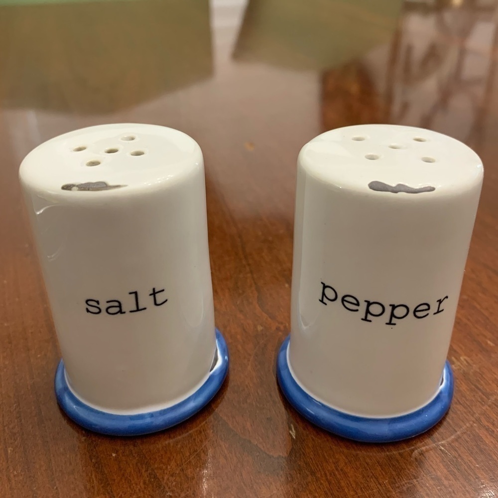 White, ceramic salt & pepper shakers w/blue base. Antiqued to look old - new